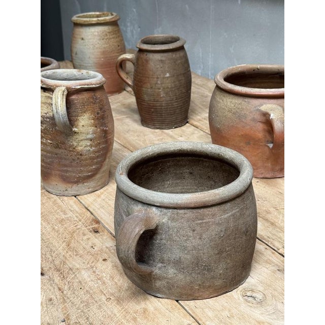 A Charming Set of single handled Stoneware Pots, France, circa 1900. All hand made with variations in size, these storage...