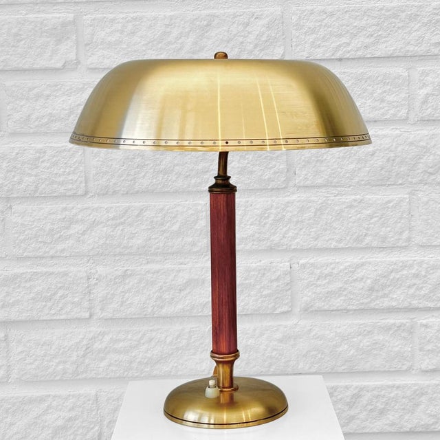 A graceful Swedish modernist table lamp, model 8451, produced by the manufacturer Boréns in the 1940s. Crafted from brass,...