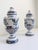 This pair of French, hand-painted ceramic urns was produced in the mid-20th century and styled after 19th-century French...