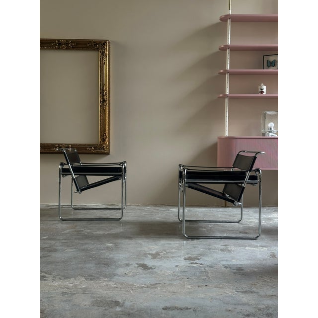 A pair of Wassily B3 armchairs, designed by Marcel Breuer in 1929 and produced by Gavina circa 1970. The armchairs have a...