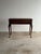 This early 20th century mahogany lift-top writing desk combines the compact footprint of a narrow console with a...