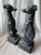 A pair of whippet or Italian greyhound dog statues seated on a shaped base. Each sculpture is lightweight and hollow and...