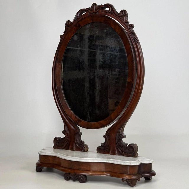 An exceptional 19th-century dressing mirror, beautifully crafted from mahogany and distinguished by its extensively carved...