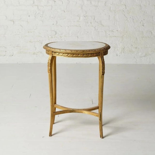 This elegant 19th-century marble and oak tea table embodies the timeless beauty of antique European furniture. Featuring a...
