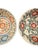 A charming pair of handcrafted ceramic bowls from Bat Trang, Vietnam, featuring two distinctive floral patterns. The first...