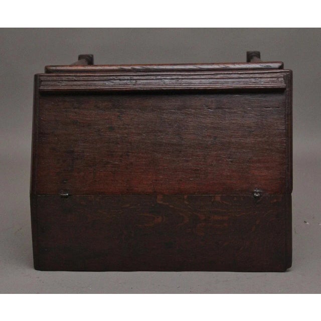 18th Century oak desk on later stand, the sloped desk having a hinged lift up lid opening to reveal a large compartment...