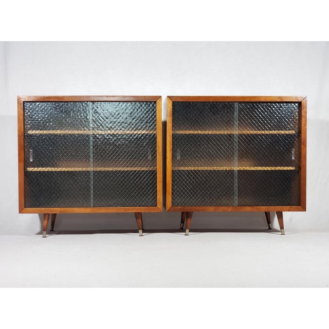 This listing is of a pair of classic Mid-Century Modern display cabinets. Clean simple shapes, wide front profile frames,...