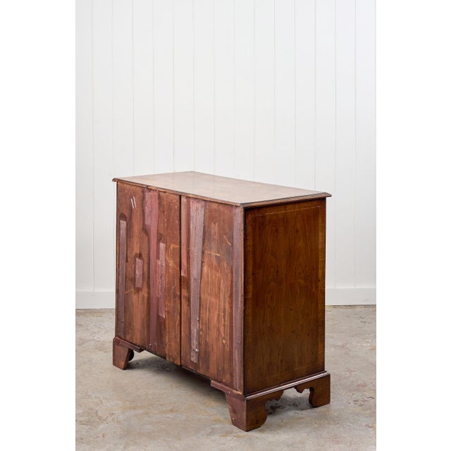 An exceptional 19th-century chest crafted from richly figured burl walnut. This piece features a two-over-three drawer...