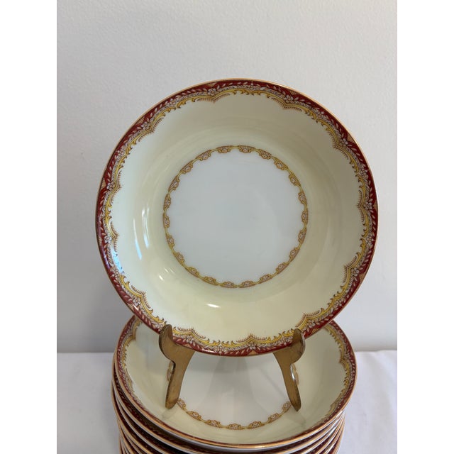 A set of 11 vintage Meito China bowls in the Celestine pattern. Each has a creamy ivory scalloped rim framed by a rust-red...