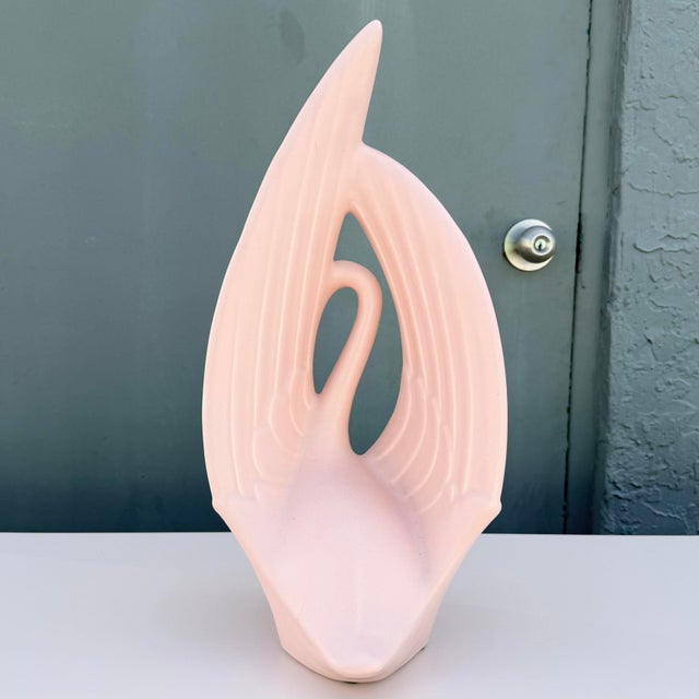 Sculptural vintage Haeger ceramic swan featuring a dramatic Postmodern form and soft blush pink glossy glaze. The stylized...