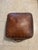 A unique vintage-style square genuine leather rustic pouf ottoman. Great to use as foot stool, extra seating or a fun...