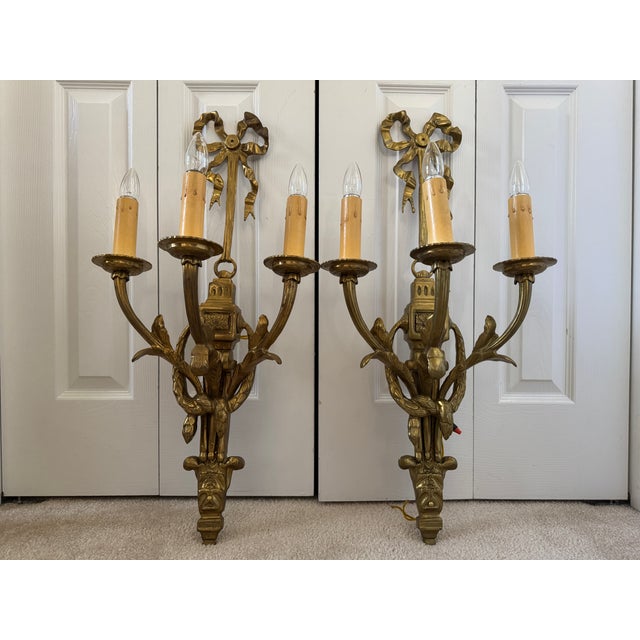 Offering for sale this stunning pair of Louis XVI-style, solid heavy brass, 3-arm wall sconces with the following fine...