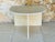 Vintage, half-moon side table/ end table/ small console table. Made of a cream colored travertine, the table features a...