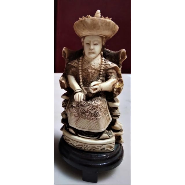 A refined pair of Chinese sculptures depicting an Emperor and Empress, finely carved in buffalo bone and presented on...