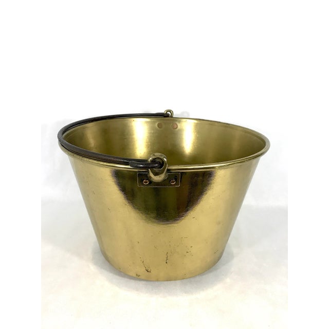 A solid brass Ansonia kettle or firewood / kindling bucket / pail with heavy cast iron handle. The piece is dated Feb. 13...