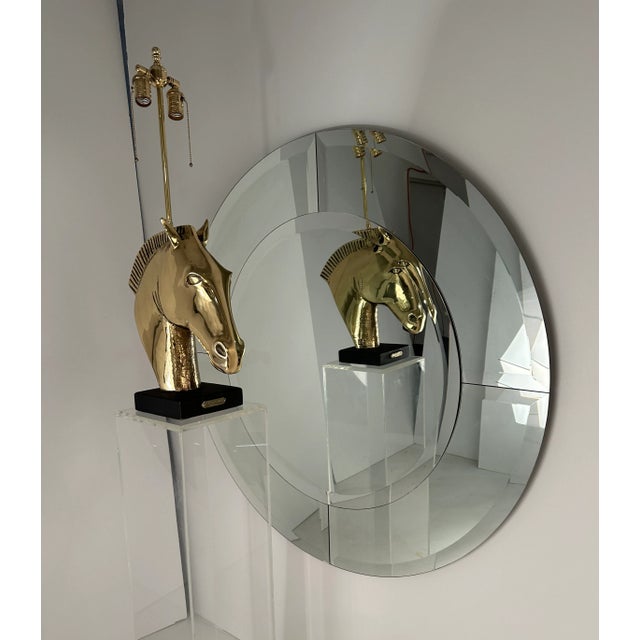 This impressive example of Karl Springer's "Saturn" mirror measures 48". The simple design is created by layering round...