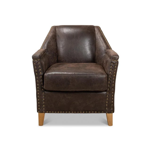 Eclectic Modern Leather Armchair with a coffee finish antiqued leather, with a+America oak legs and large nailhead trim...
