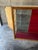 Large wooden and glass shop display case dating from the 1930s. Glazed on the front and sides, it features a red interior...