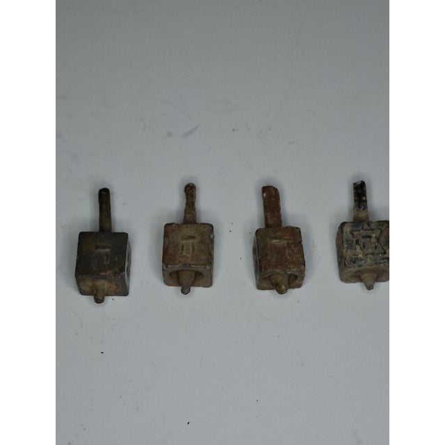 This listing features a set of antique dreidels, small spinning tops used in the traditional Jewish Chanukah game. These...