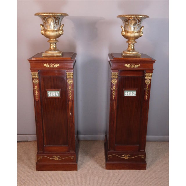 Pair of mahogany cabinets with sycamore interiors, Napoleon III period. Each cabinet opens with a door adorned with a...