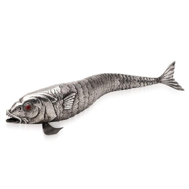 A 20th Century large articulated fish from Mexico, made in alpaca silver and set with red stone eyes. The segmented...