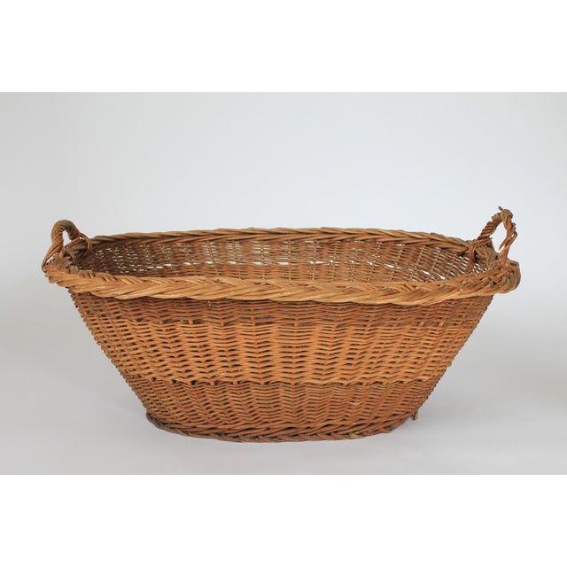 Vintage woven wicker laundry basket w/ handles. Made in Yugoslavia. Makers stamp on bottom. Condition notes: Some breakage...