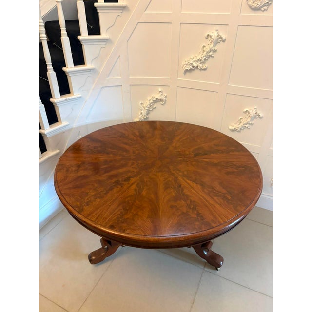 An antique Regency figured mahogany circular tilt-top dining and centre table with a striking segmented top, unusual...