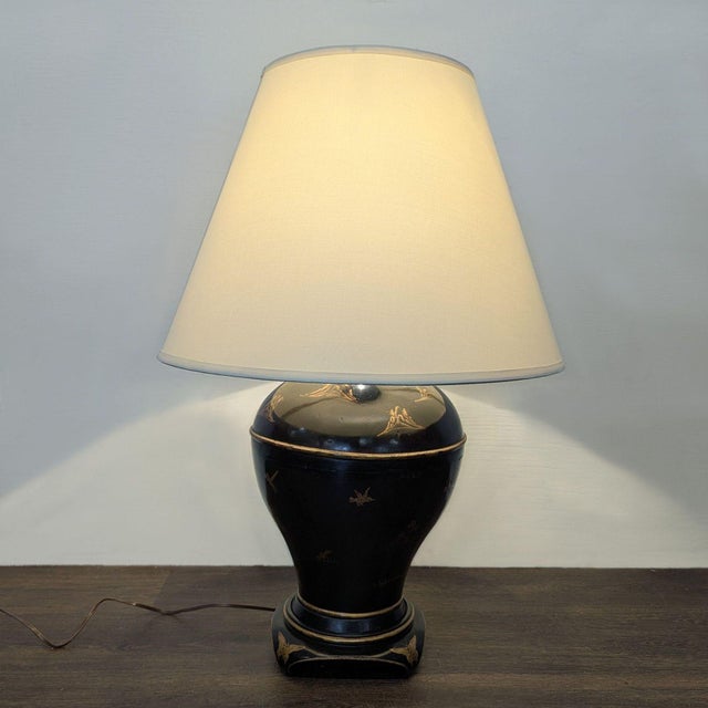 Chinoiserie-style table lamp featuring a black lacquer-style finish with hand-painted gilt decorative motifs, baluster-...