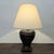 Chinoiserie-style table lamp featuring a black lacquer-style finish with hand-painted gilt decorative motifs, baluster-...
