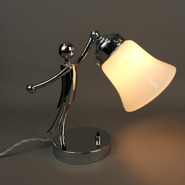 Rare figural table lamp made of masiv brass, chrome-plated, with adjustable shade. The lamp has been rewired and re-...