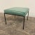 Ottoman/stool based off a design by Paul McCobb. This piece has an iron base and was covered in a teal leather.