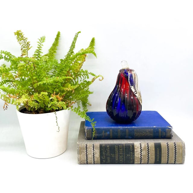 Luminescent blown glass paperweight in the shape of a pear. Made in the mid-late 20th century in Murano, Italy. Maker’s...