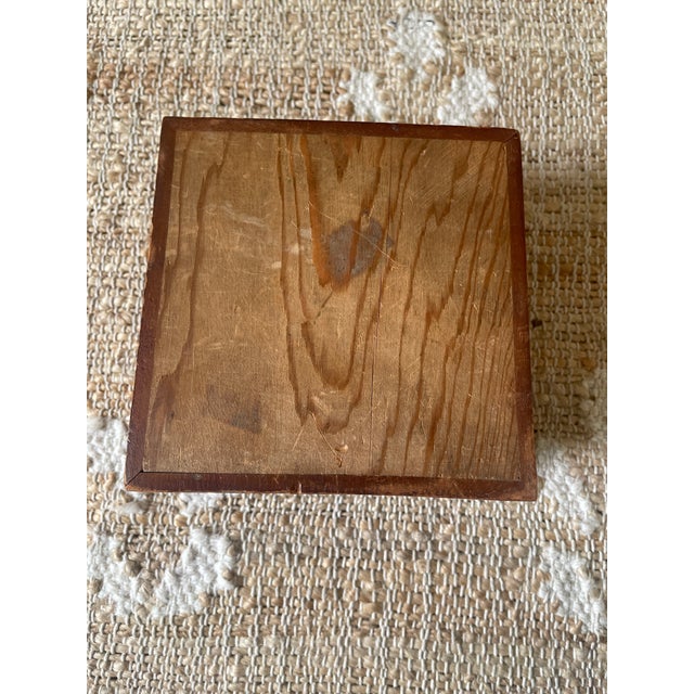 This vintage wooden square trinket dresser box features geometric parquetry marquetry, giving it a unique and charming...