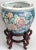 Offering a vintage porcelain teal colored gold fish bowl planter with pink peonies and lavender violets with wood stand,...
