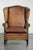 This elegant sheepskin wing armchair features a beautiful color scheme and a lovely patina. The armchair has a loose seat...