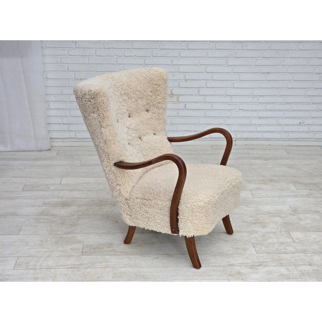 1960s, Danish design by Alfred Christensen. Completely renovated high-backed armchair. Quality genuine sheepskin from New...