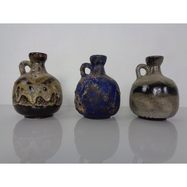 Set of 3 lava ceramic vases by Otto Gerharz for Ruscha. Model 333. All 3 ceramics are in very good condition. This piece...