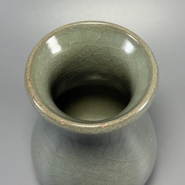 Fine antique Chinese celadon pear‑form vase. Flared wide rim, short neck and plump pear‑shaped body, covered in natural...