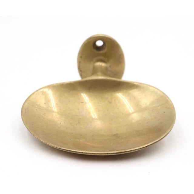 Vintage oval shaped unlacquered brass surface mount wall soap dish. The original mounting screws are not available. Good...