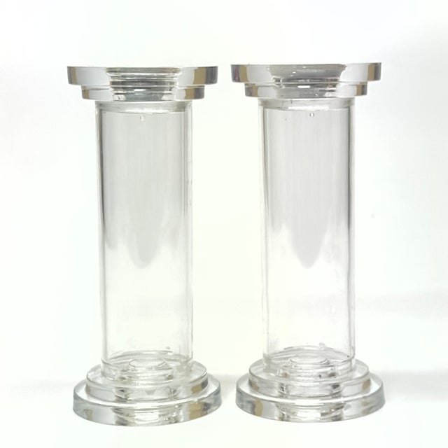 Lucite candle holders, set of 2. A stunning pair of clear Lucite hollow candleholders with a sleek cylindrical design and...