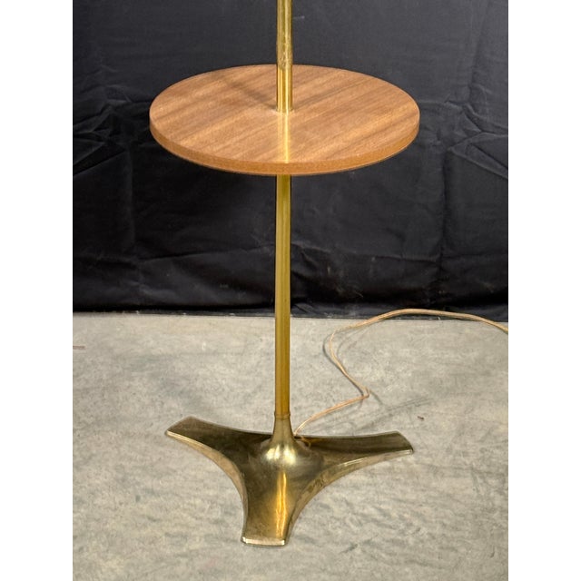 Beautiful vintage mid century modern brass floor lamp with integrated side table, very much in the manner of pieces by the...