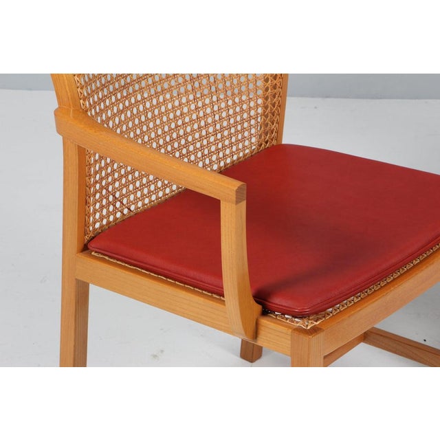Ditte Heath armchairs in elm. with cane in the back Original upholstered with red leather. Made by Søren Horn This piece...