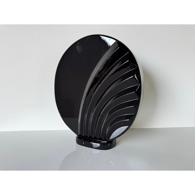 This striking 1980s Postmodern ceramic vase features a bold Art Deco-inspired fan motif, rendered in a high-gloss black...