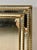 Elegant wall mirror featuring a sophisticated brass frame with decorative beaded detailing and beautifully beveled...