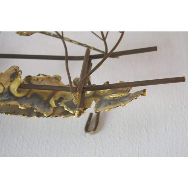 This is a mid century modern Brutalist hanging wall art sculpture of a covered bridge, artist signed by Curtis Jere. It is...