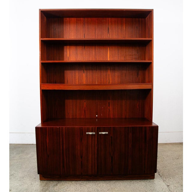 Danish Modern Rosewood 2 piece cabinet with shelving above. This piece was produced in the 1960s and was acquired from the...