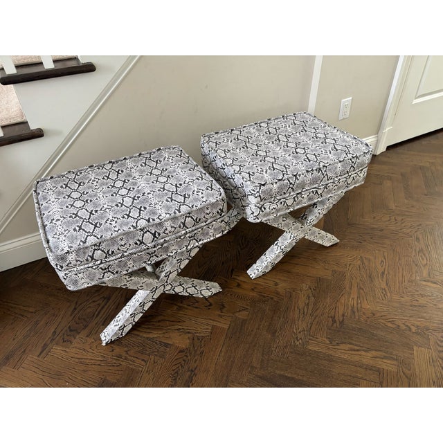 Sophisticated pair of upholstered benches featuring a tailored faux python leather upholstery in a classic black-and-ivory...