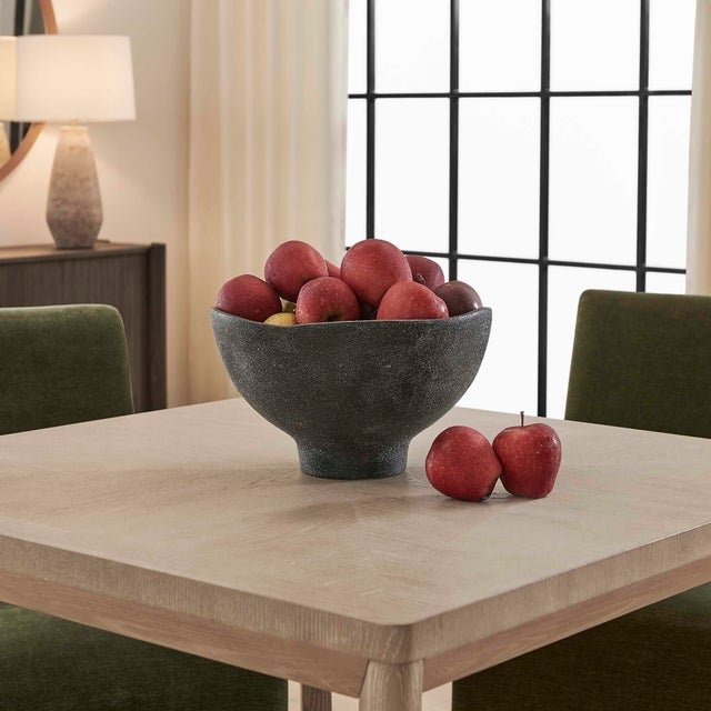 Crafted From Earthenware, This Bowl Has A Unique, Organic Shape With A Subtly Waved Rim. Its Matte Black Finish Features A...