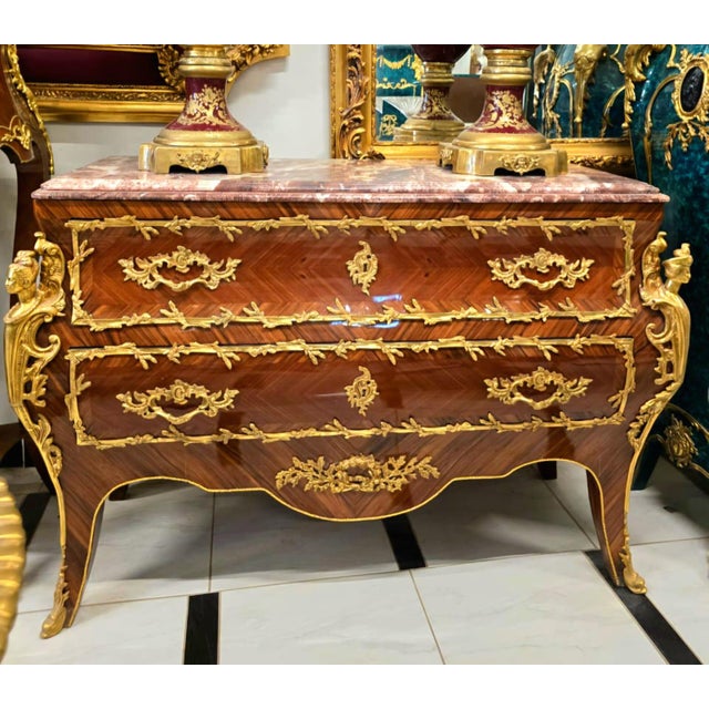 A true masterpiece of French-inspired luxury, this stunning Louis XV Bombe Commode showcases an elegant serpentine...