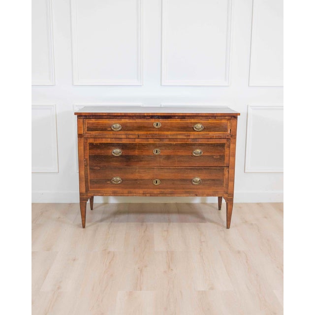An elegant Italian late 18th to early 19th century chest of drawers, masterfully veneered in richly figured rosewood,...